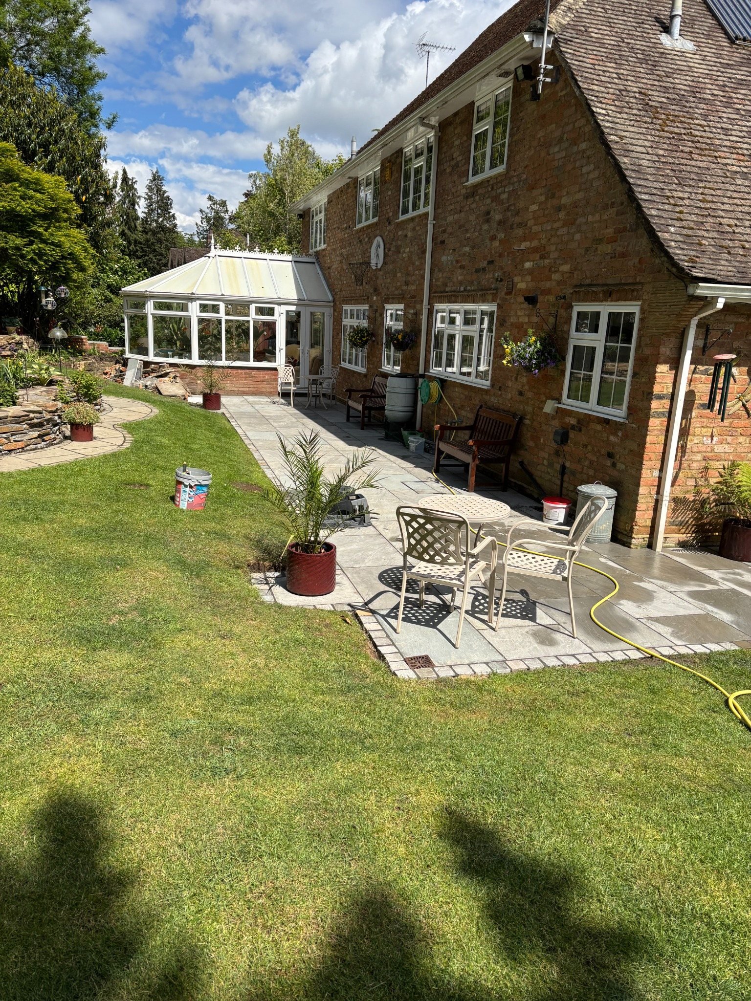 Stone patio alongside a landscaped garden